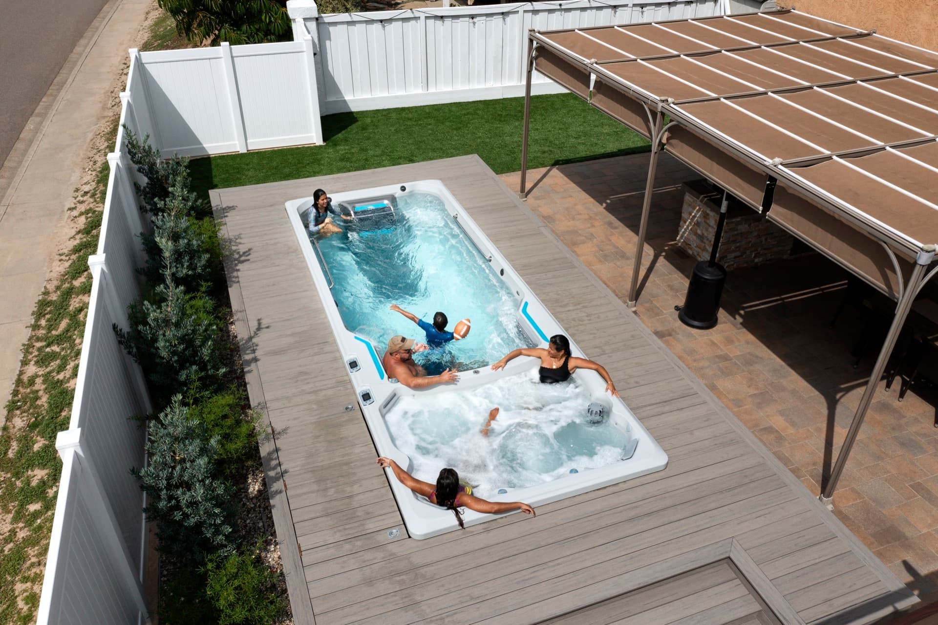 Family swimming and soaking together in an Endless Pools E2000 dual-zone swim spa
