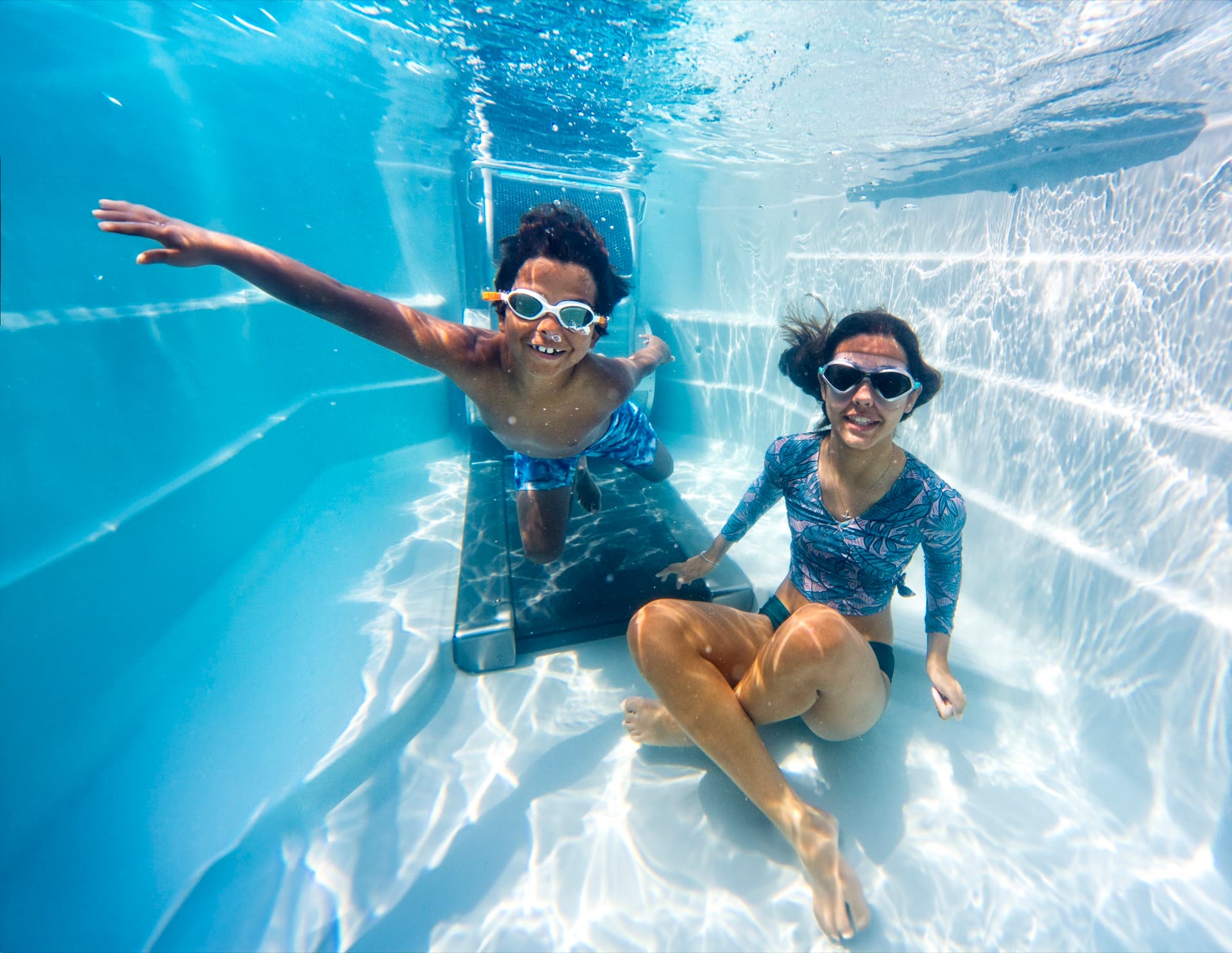 Kids playing underwater in an Endless Pools swim spa