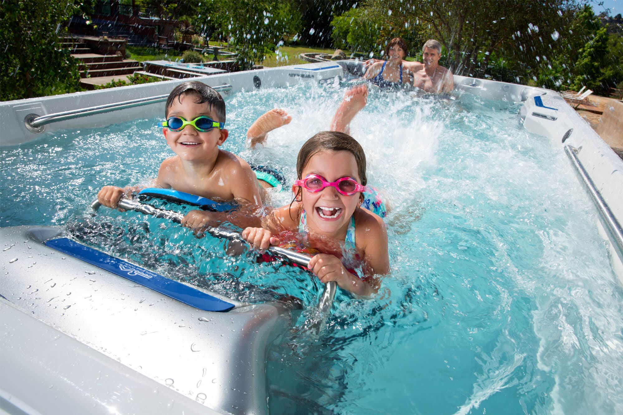Kids splashing and playing in an Endless Pools E500 swim spa