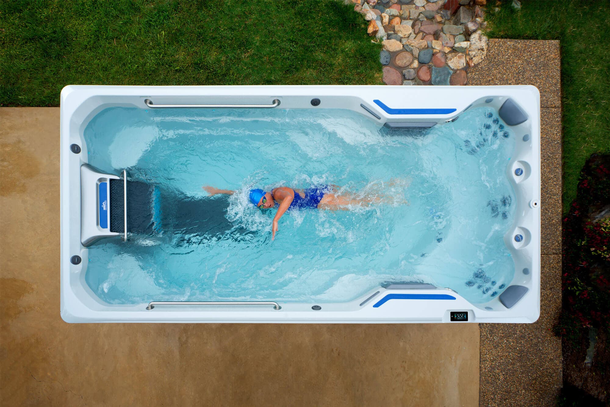A swimmer training against the Hydrodrive current in an Endless Pools swim spa