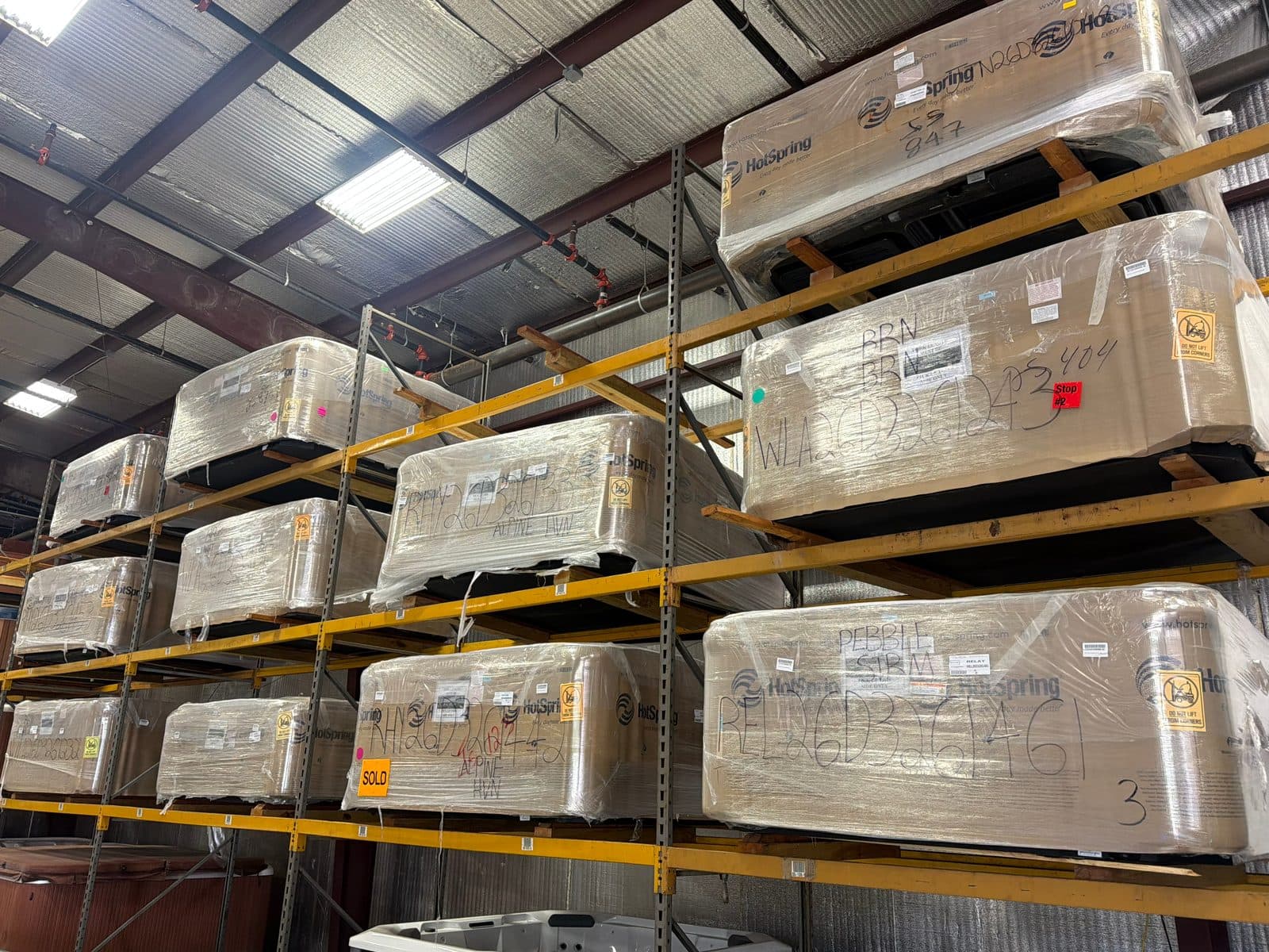 New hot tubs still wrapped on the racks in our Tyler warehouse. The Highlife Jetsetter LX is one of them.