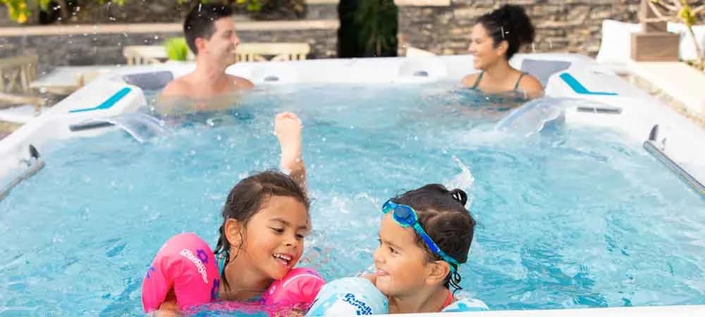 Endless Pools X500: family using the swim spa. Manufacturer photograph.